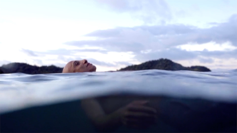 Swimmer floating peacefully in ocean
